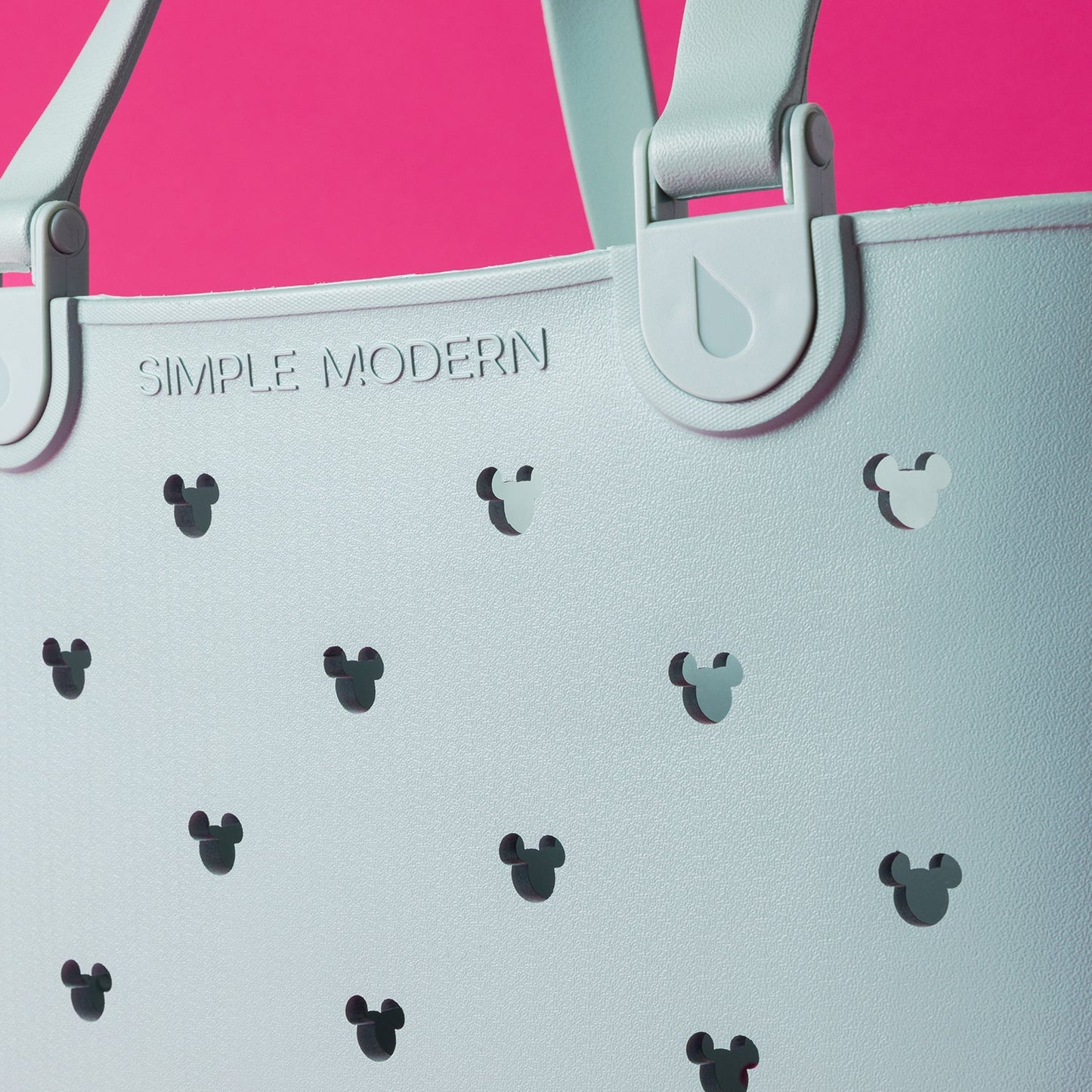 Light mint green tote bag on hot pink background