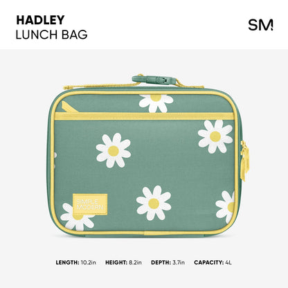 Soft sage green Hadley lunch bag with golden yellow handles and trim, decorated with white and pale yellow daisy flowers scattered across the front.
