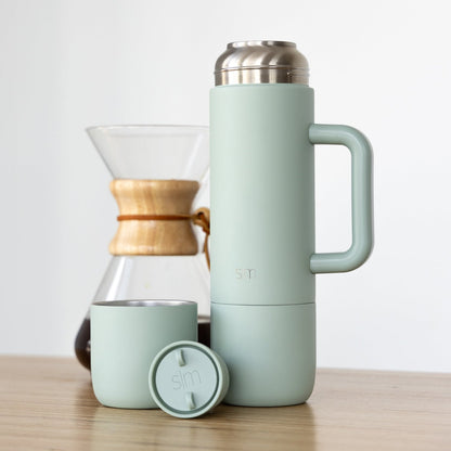 Soft mint green skincare and wellness products arranged with natural wood accents and brushed stainless steel finishes